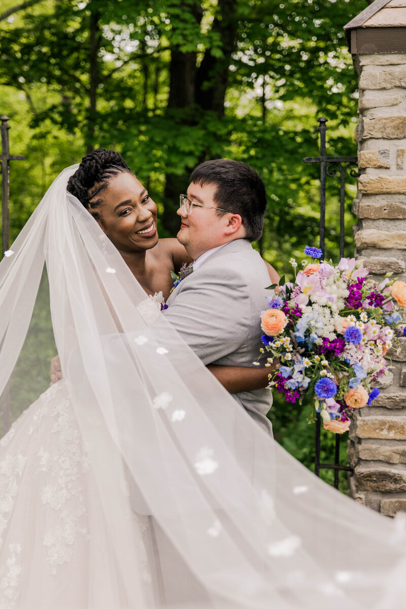 Cincinnati Nature Center spring wedding of interracial couple holding onto each other smiling