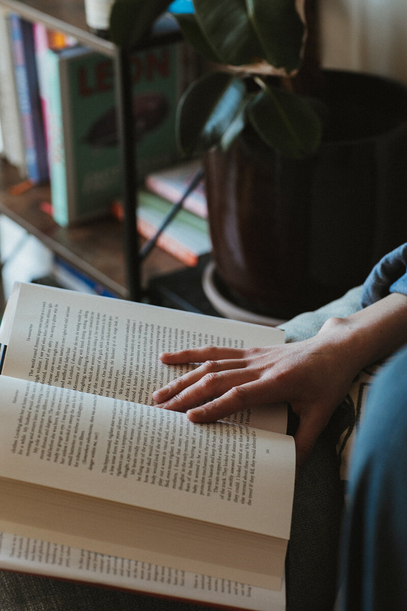Book on motherhood, "Matrescence" is open as female business coach reads