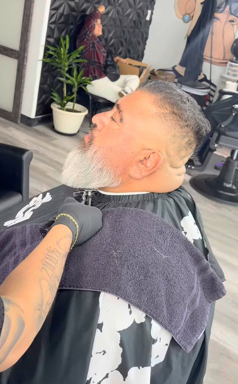 A barber doing a beard trim at Onyx Barbershop in Wildomar, CA.