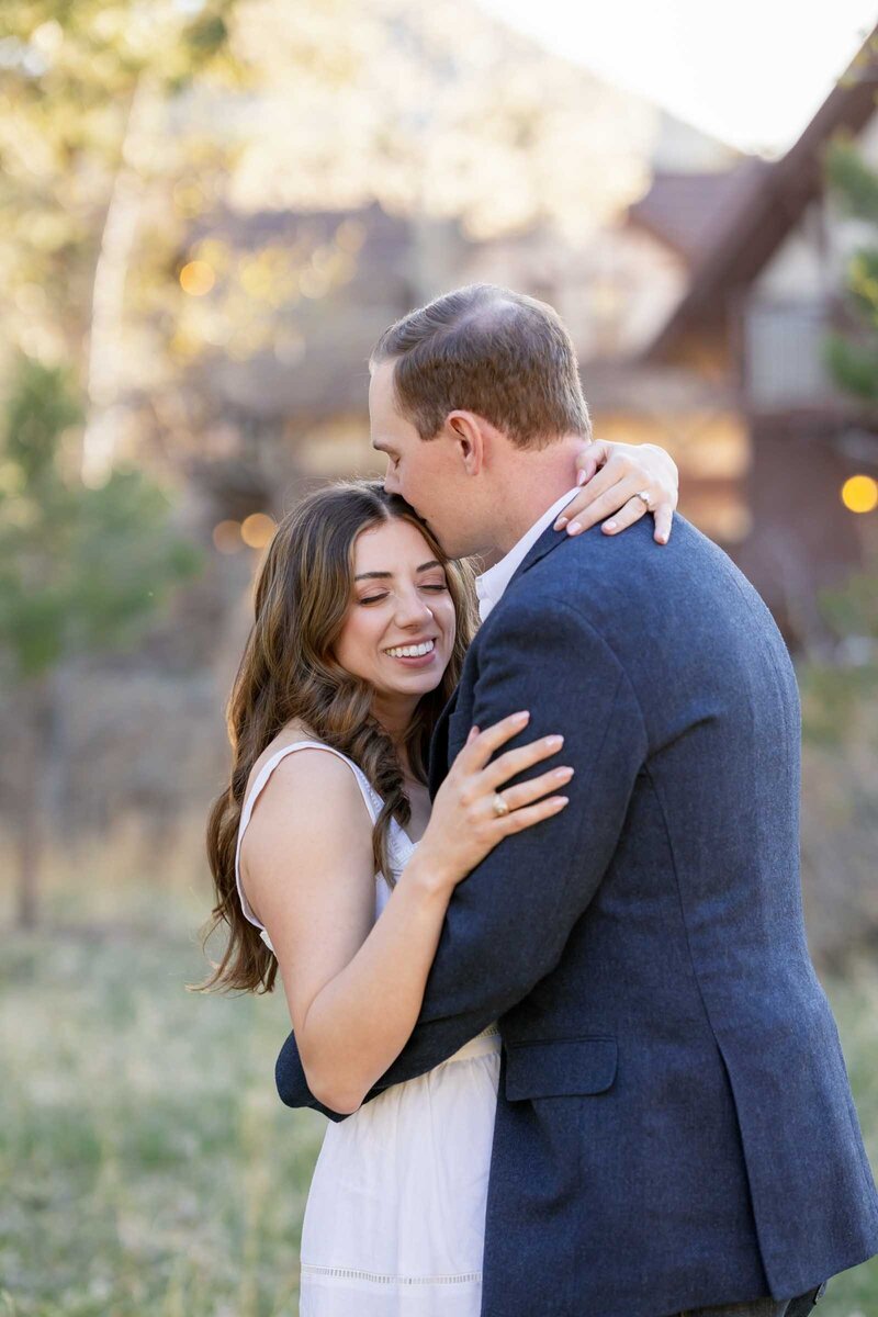 Couple embraces during their rehearsal dinner in Estes Park, Colorado. 