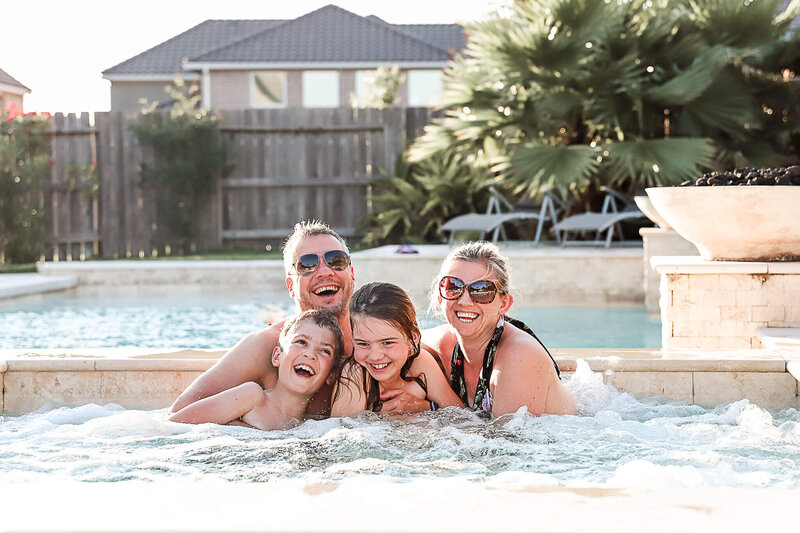 Family laughing in hot tub