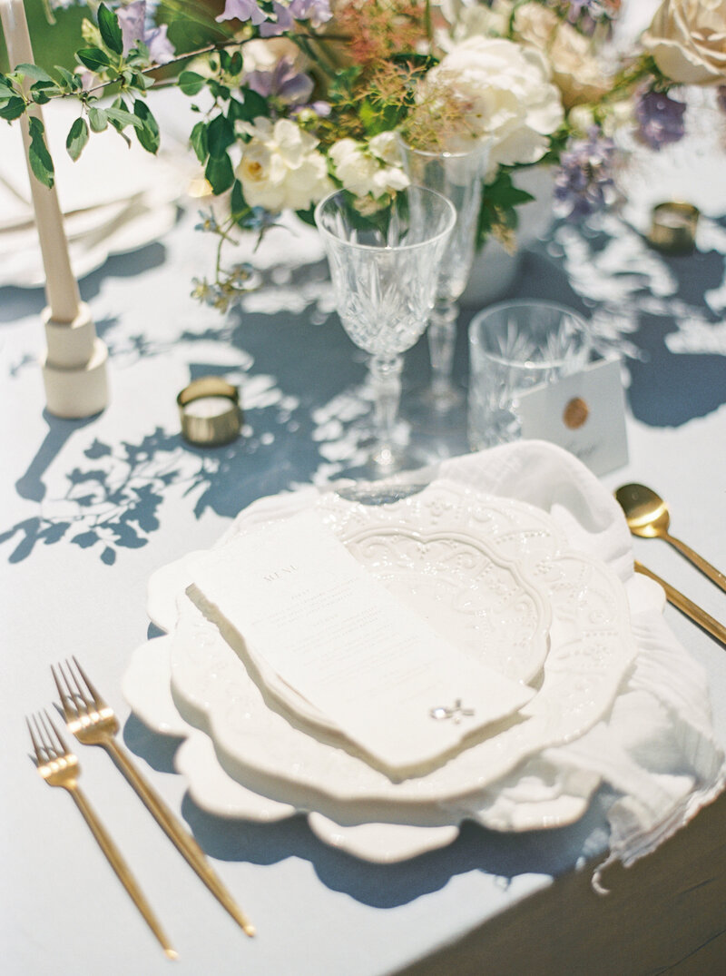 Light Blue Table Setting With Purple and Peach Flowers