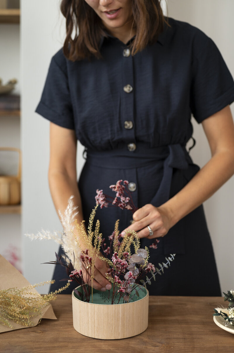 front-view-smiley-woman-working-with-flowers