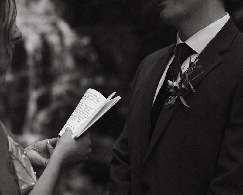 Intimate elopement ceremony in the stunning Columbia River Gorge, with lush green cliffs and a flowing river in the background.