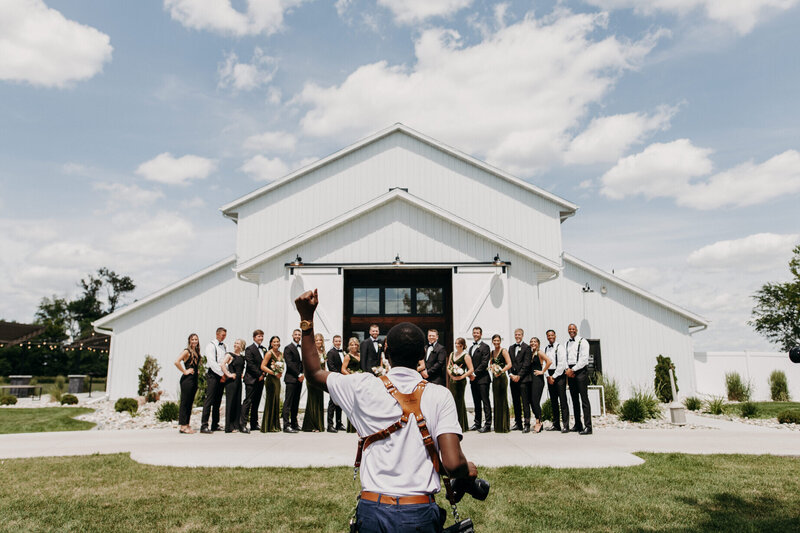 photographer coordinating bridal party photos