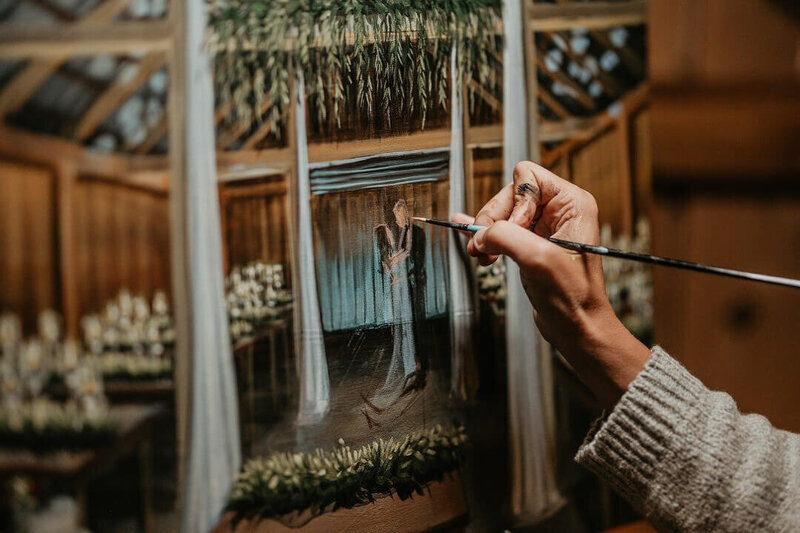 artist painting a live wedding painting of couple's first dance at the Inn at Grace Winery