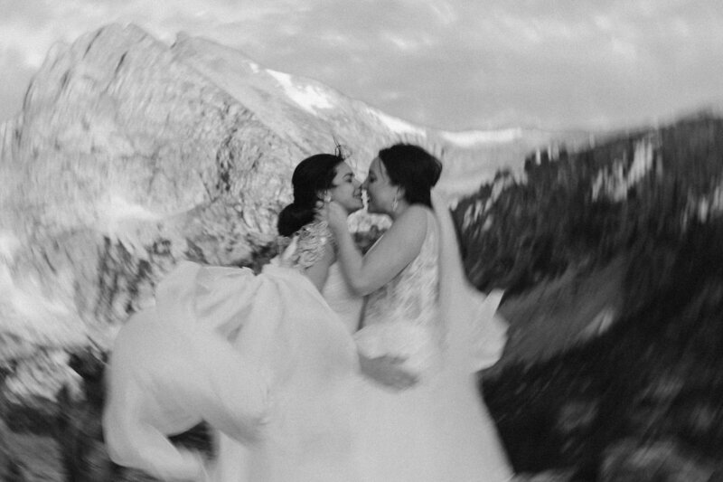 black and white image brides kissing