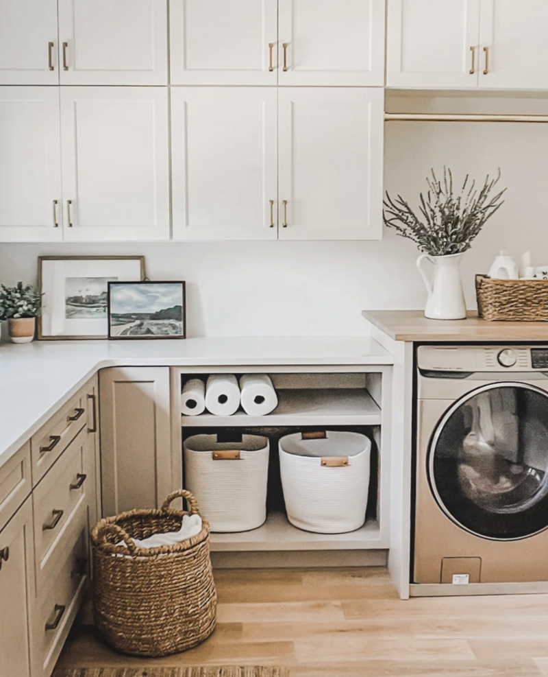 In the laundry room, Kohler's durable farmhouse sink is paired with a Moen faucet with convenient pull-down sprayer