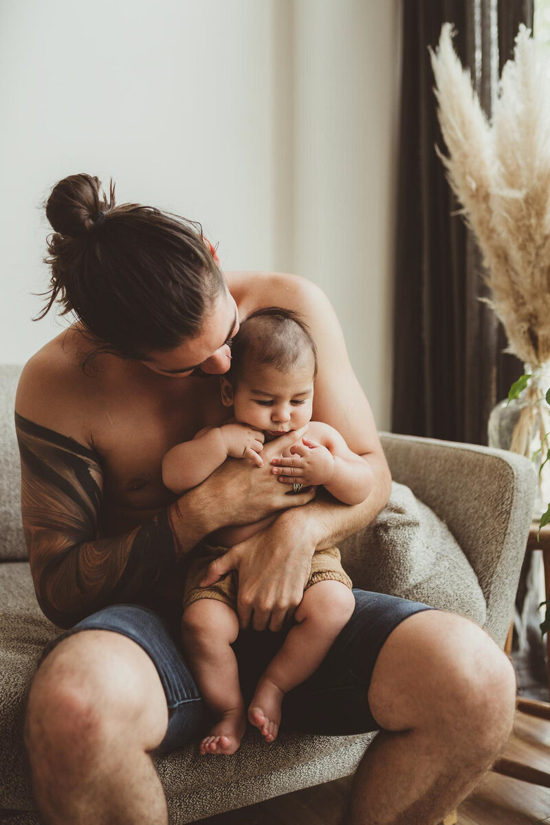 father and daughter newborn baby hugging