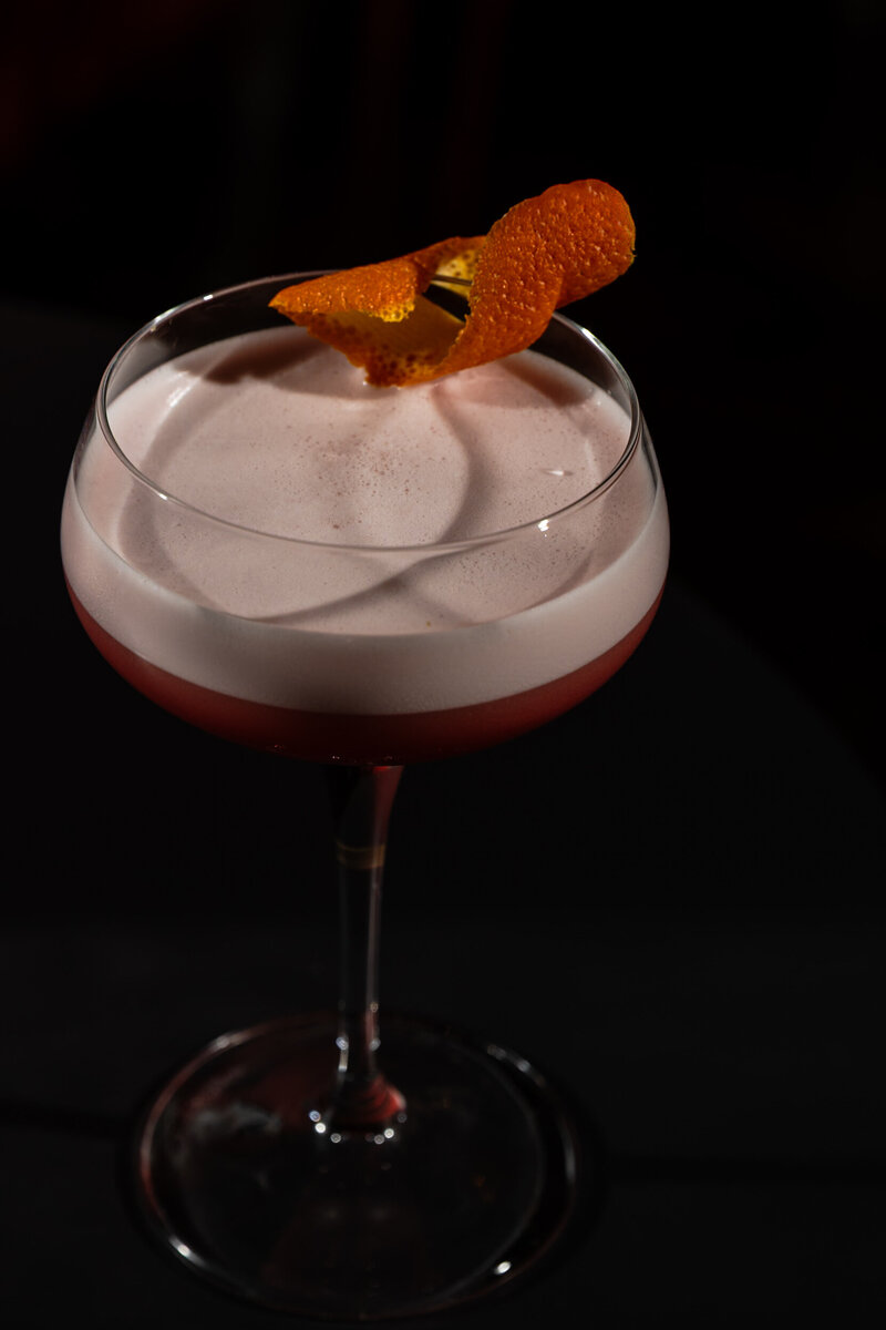 Campari Shakerato in coupe glass with orange peel