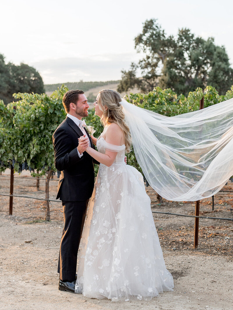  A fairytale style wedding reception with overflowing florals and glass chairs at the Moxie museum in Santa Barbara.