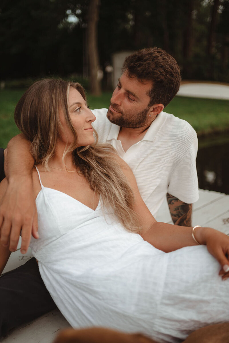 Couple lying together on the grass during a relaxed session in a park in Pennsylvania