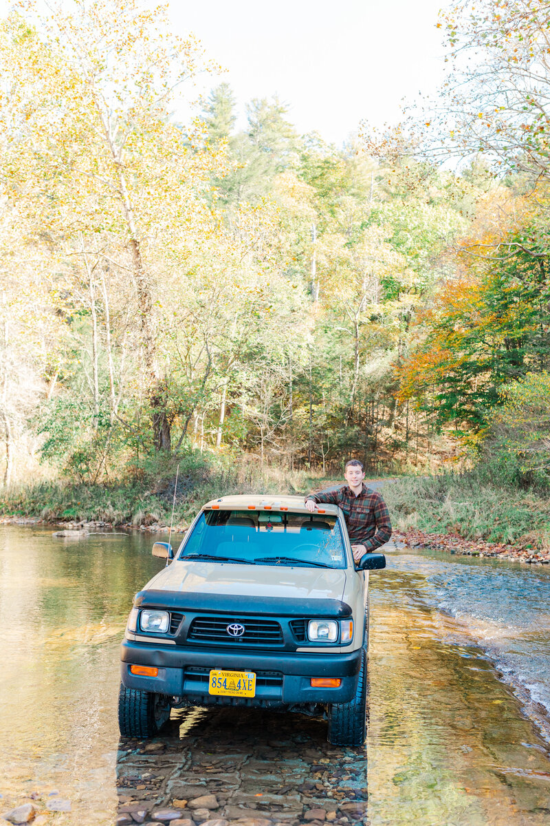 Senior graduation photos at Fort Defiance High School, VA, featuring a truck in the river for a unique and adventurous photo session