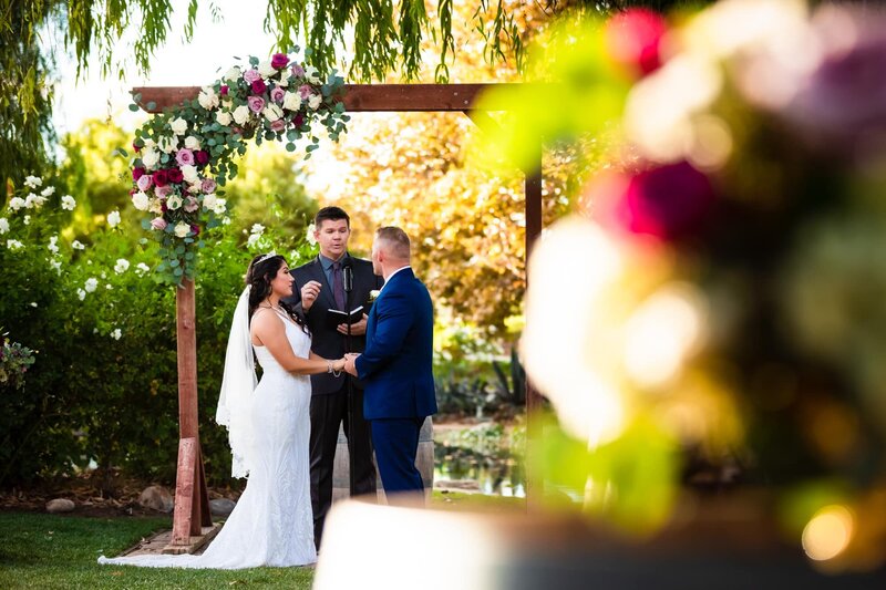 Bride and groom holding hands at their wedding ceremony at Galway Downs by Wedgewood Weddings in Temecula