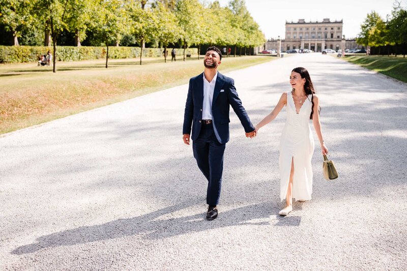 Couple walking towards the boat pier after they got engaged to go on a boat ride.