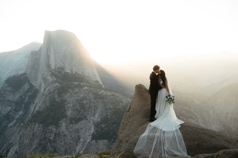 Bride and Groom kissing at sunrise at the best Yosemite Wedding Location: Glacier Point