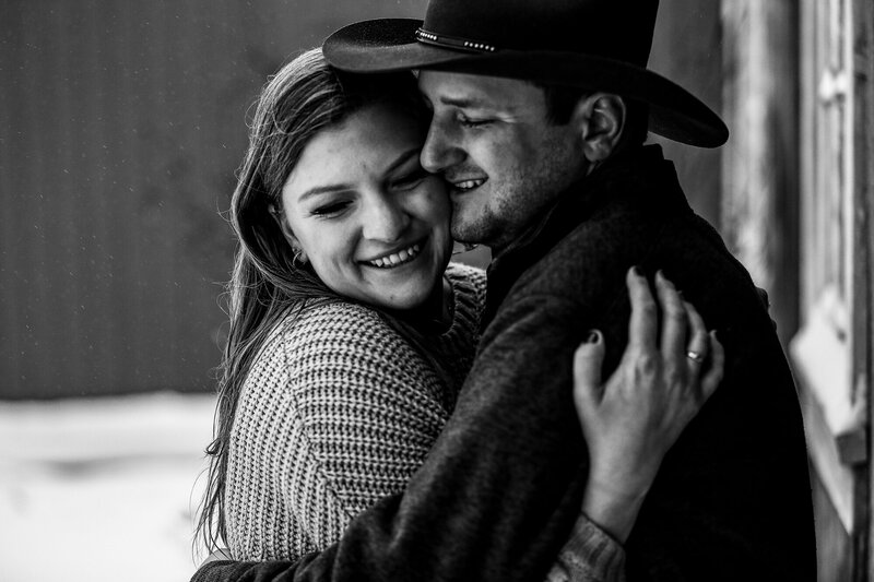 Engaged couple hugging and smiling