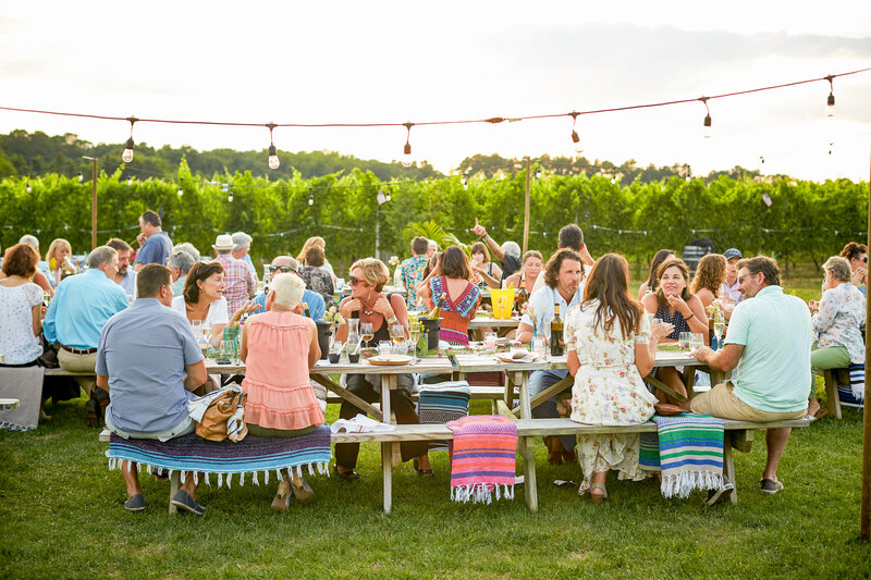 Group of people sitting at tables at a fun event