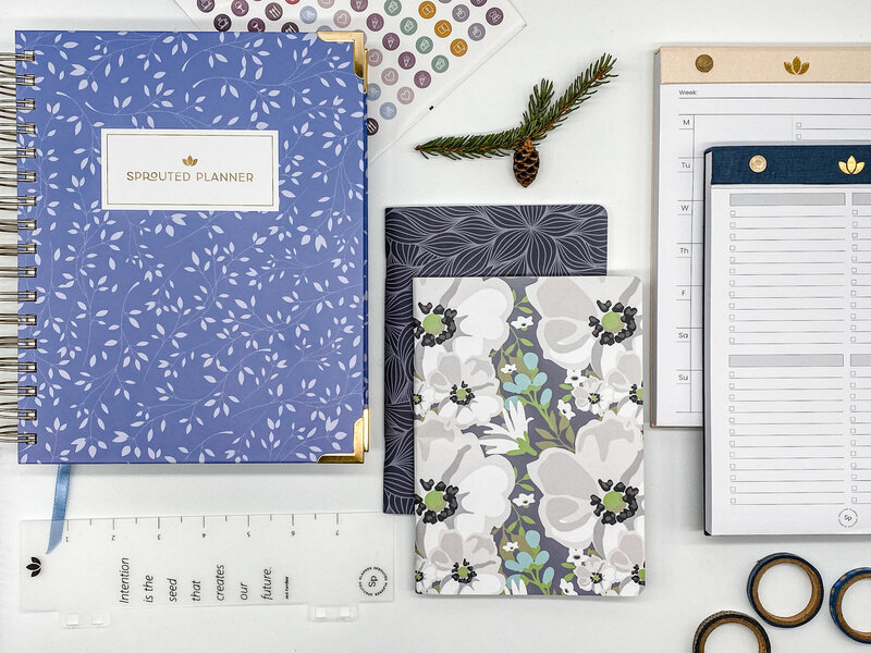 collage of blue spiral planner and other paper products
