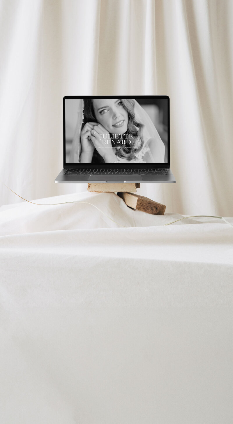 Laptop displaying the elegant Juliette Renard Showit template, showcasing the finished product of website design by The Soft Voice.
