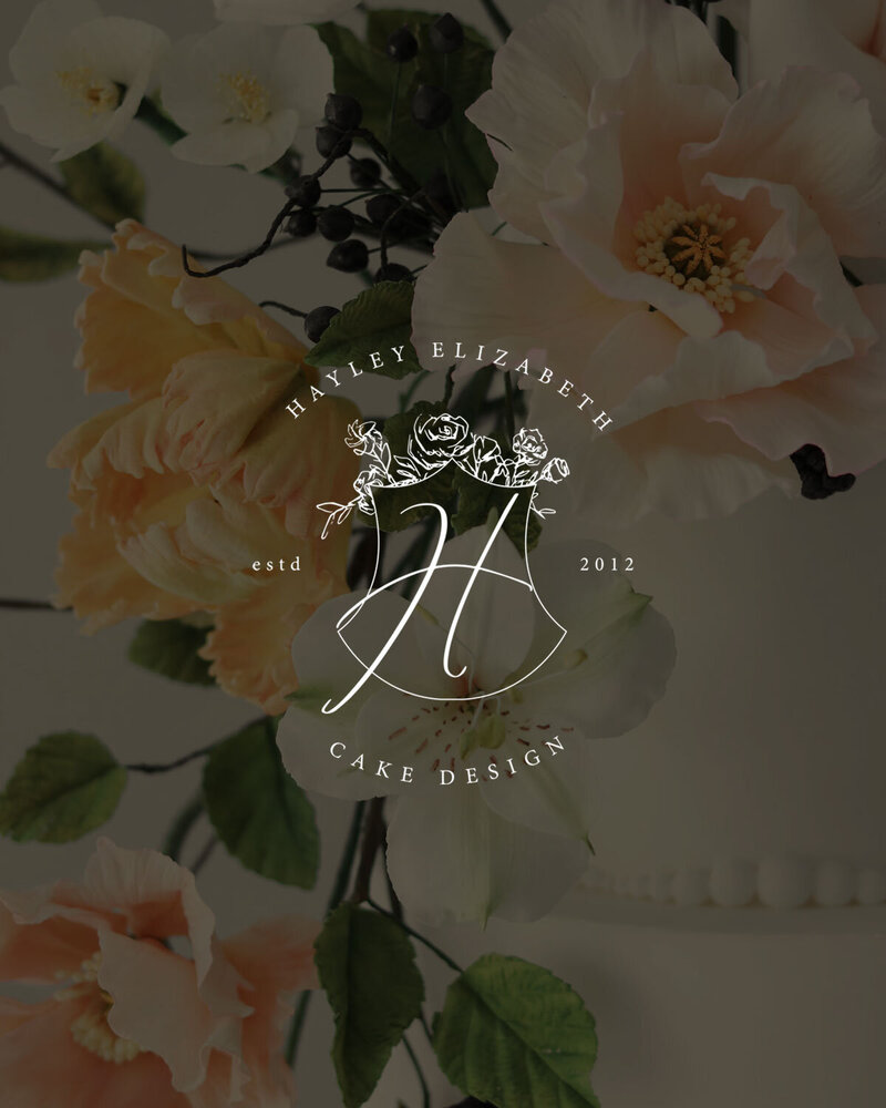 Elegant green branding with white floral emblem for Hayley Elizabeth, designed by Sarah Shuttle Luxury Brands
