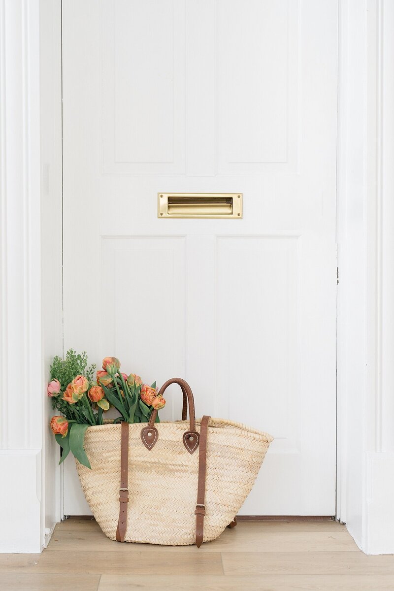personal branding photos with florist bag of flowers sitting in a door way for Columbus Ohio small business photos