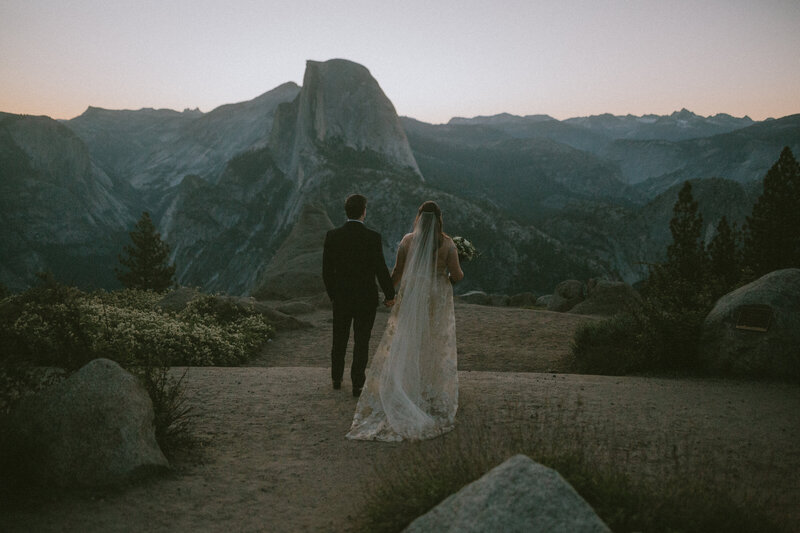 Bride and groom walking hand in hand at their Yosemite elopement, coordinated by Beyond the Event