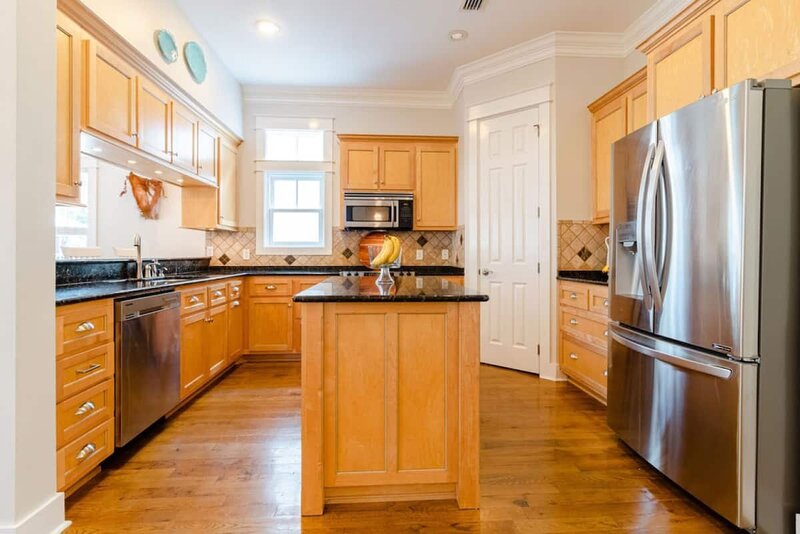 kitchen with island and stainless steel refrigerator