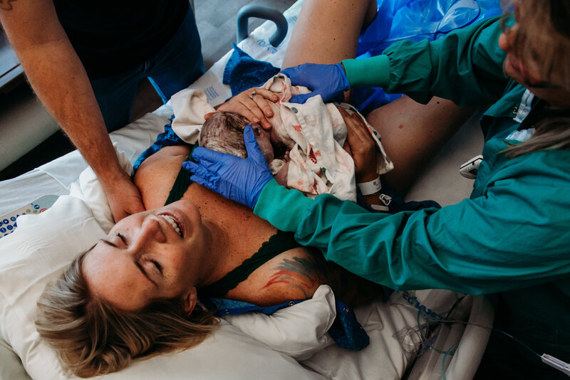 photo of mom full of relief after birthing her baby at Longs Peak hospital in Firestone Colorado