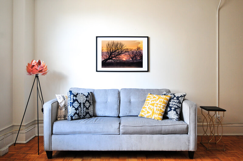 Framed  picture of a sunset in a living room