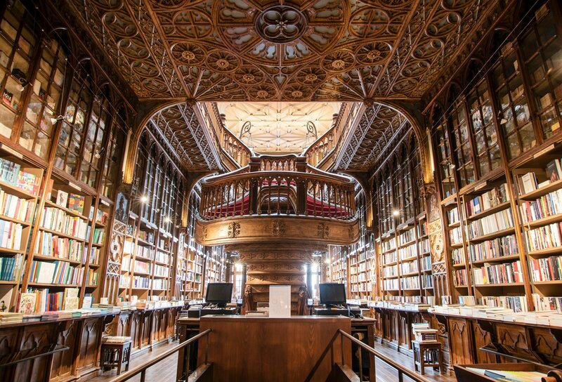 Grand historic library with floor-to-ceiling bookshelves, ornate staircase, and detailed molding, reflecting a deep tradition of literature, copy editing, and professional proofreading services.