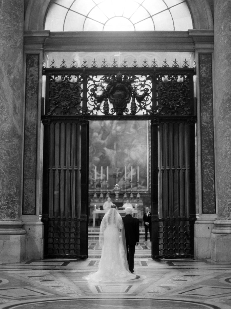 Dad and bride walking into the vatican during their ceremony