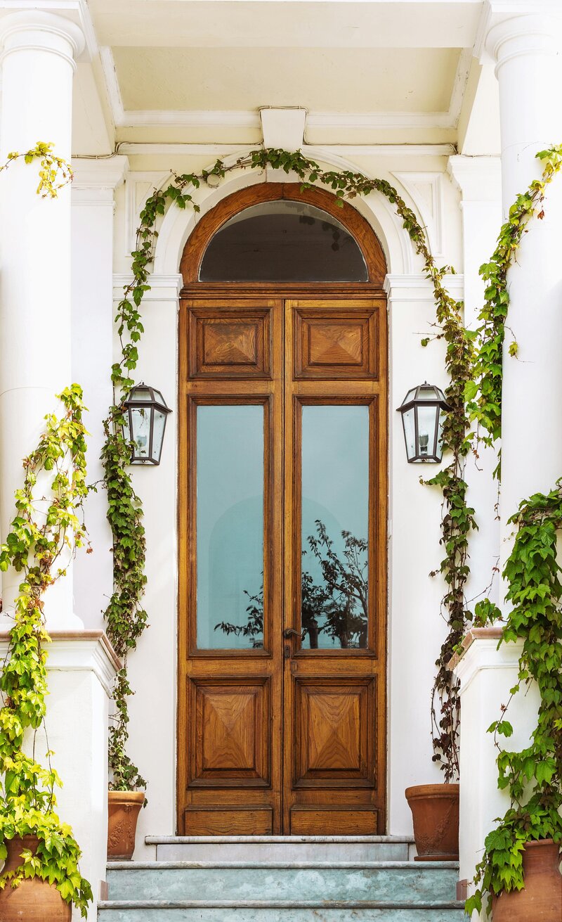 Historical kitchen. Custom kitchen renovation. Kristina Anne Designs. Grand manor front door with growing ivy. Matching black exterior sconces. Stone steps.