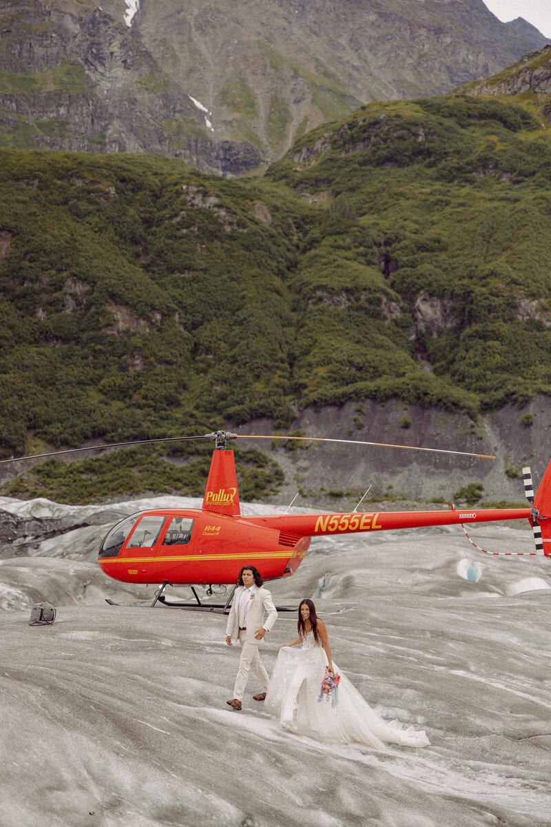 Couple getting off a helicopter during their Alaska Elopement with Jamie Tobin Photography