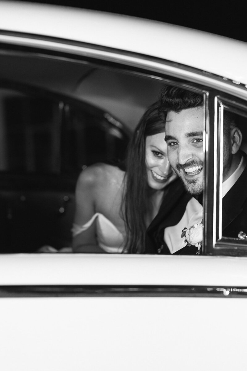 bride-and-groom-smiling-in-car