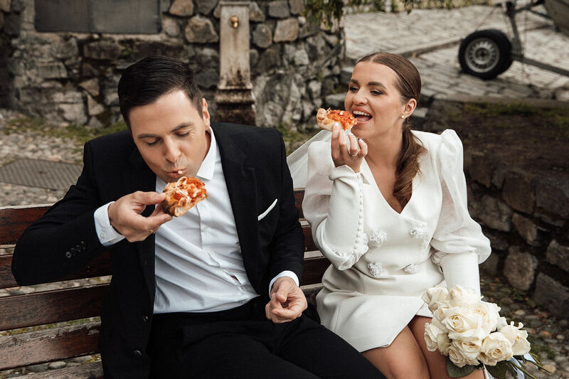 Wedding couple eating Pizza on their wedding day in Italy