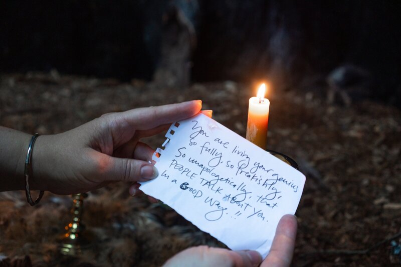 Oracle Business Witch Rachael Maddox holding a piece of paper that reads, "You are living your genius unapologetically so that people talk about you in a GOOD way."