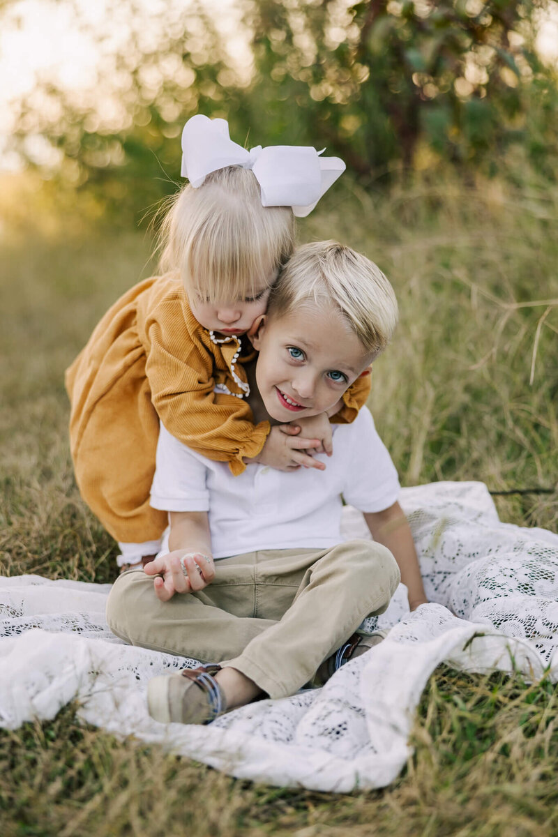 Big brother and littles sister sharing a sweet moment during their Augusta family and motherhood photography session