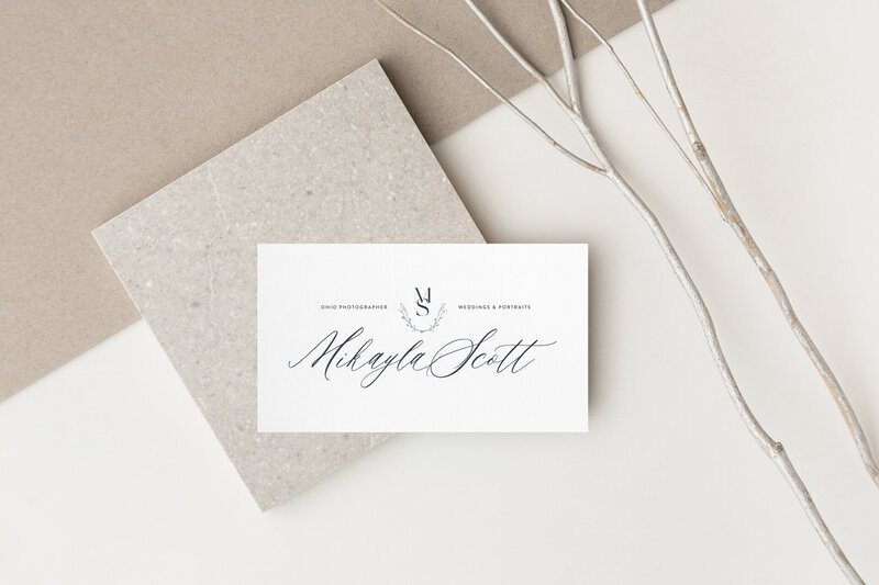 a mockup of a logo with script on stationery