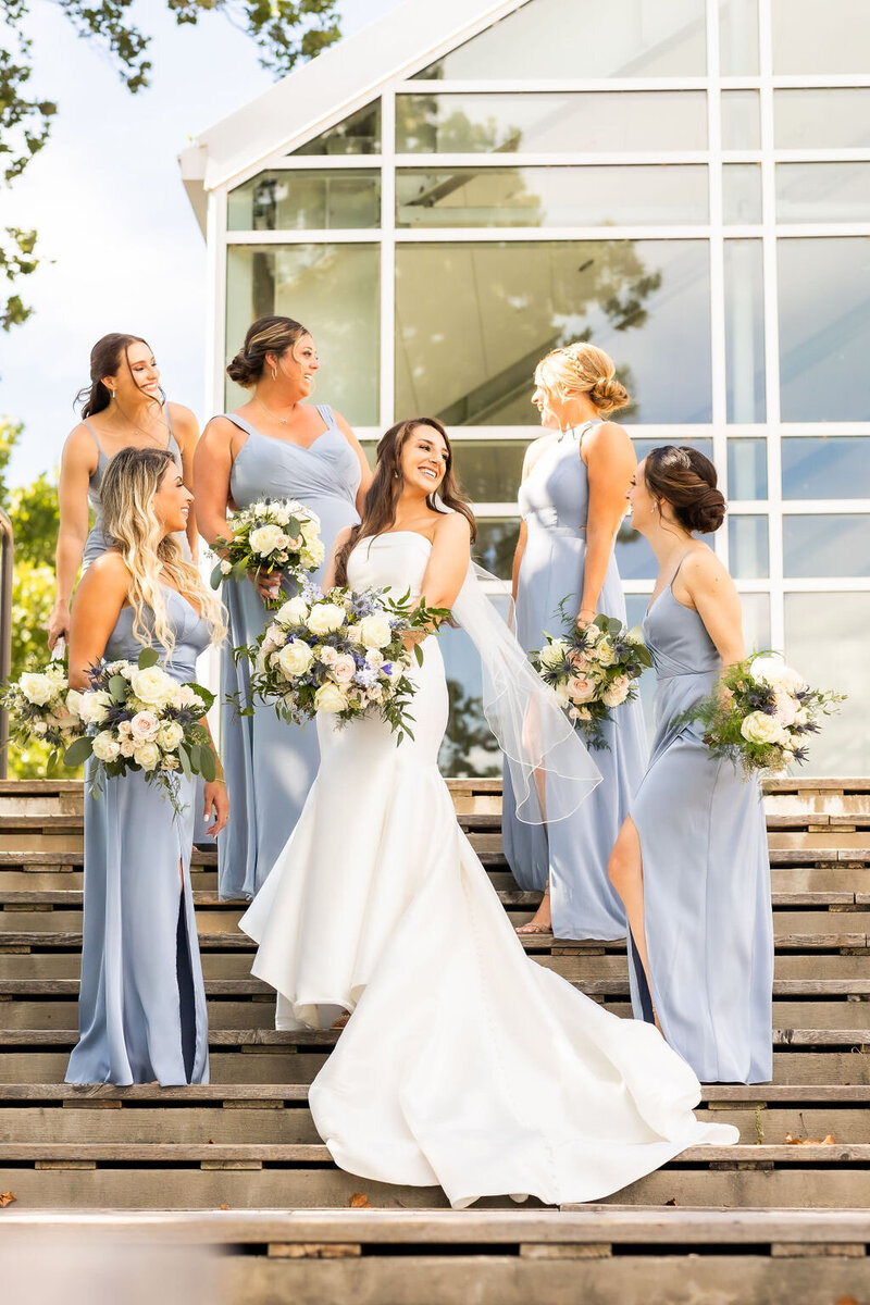 Bride and bridesmaids giggle on the steps at Riverview at Occoquan, Virginia Wedding Photos