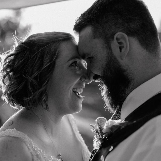 bride and groom hugging their son for a dance