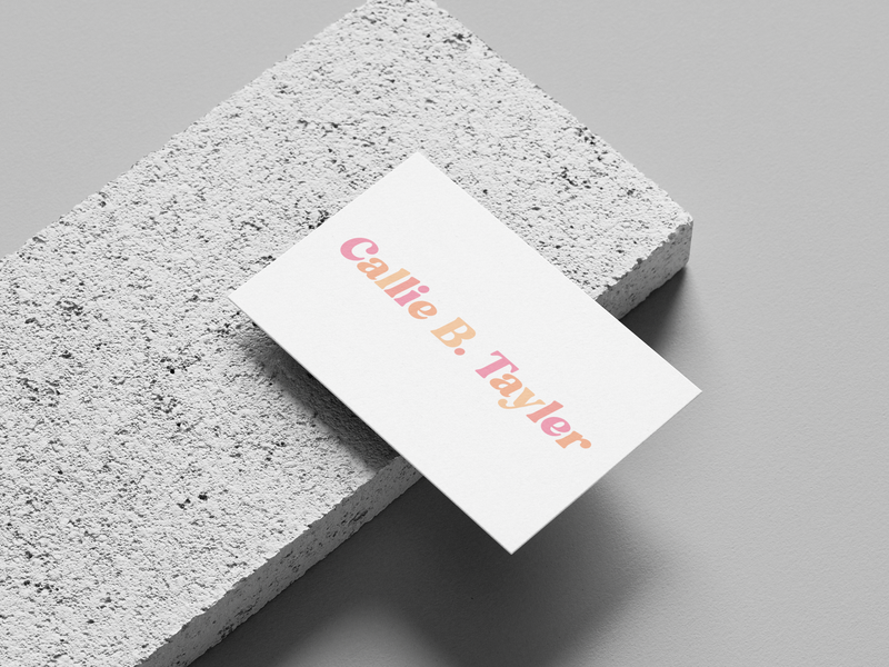 A white business card with "Callie B. Tayler" in gradient pink-to-orange text rests on a textured concrete block.