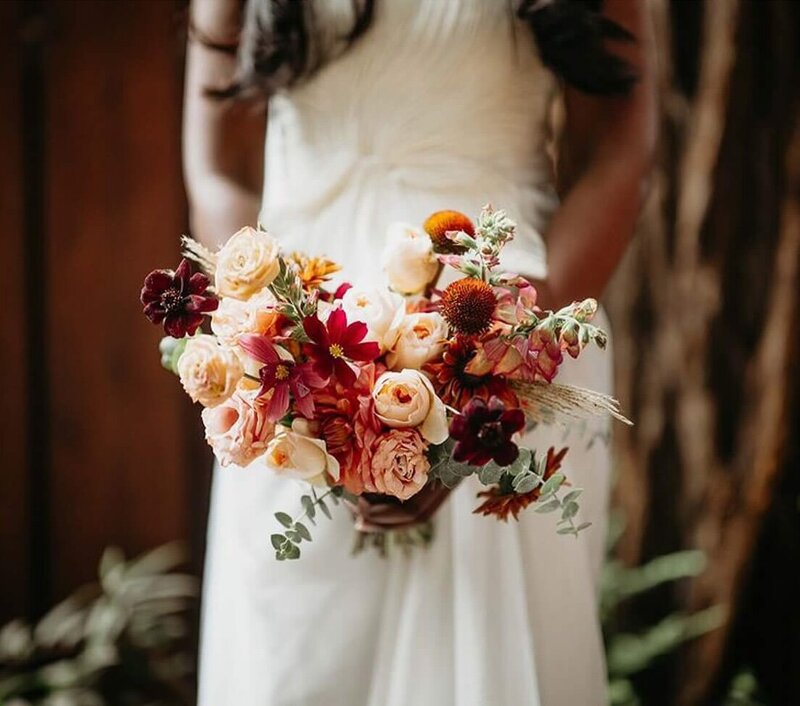 Flowers in warm fall colors at a Ventana Big Sur wedding