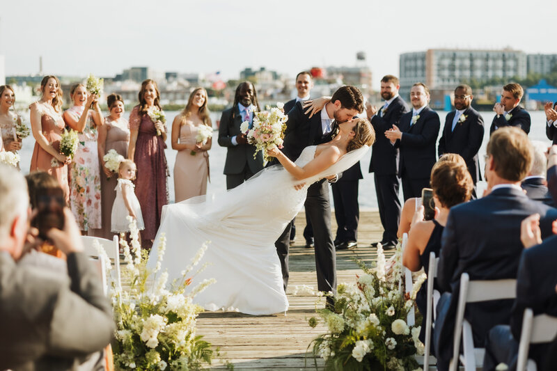 Groom dips his bride on the pier, Baltimore Wedding Photographer Kimberly Dean