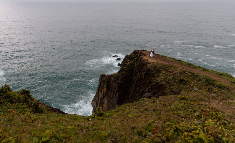 Couple on a cliff edge on the Oregon Coast.