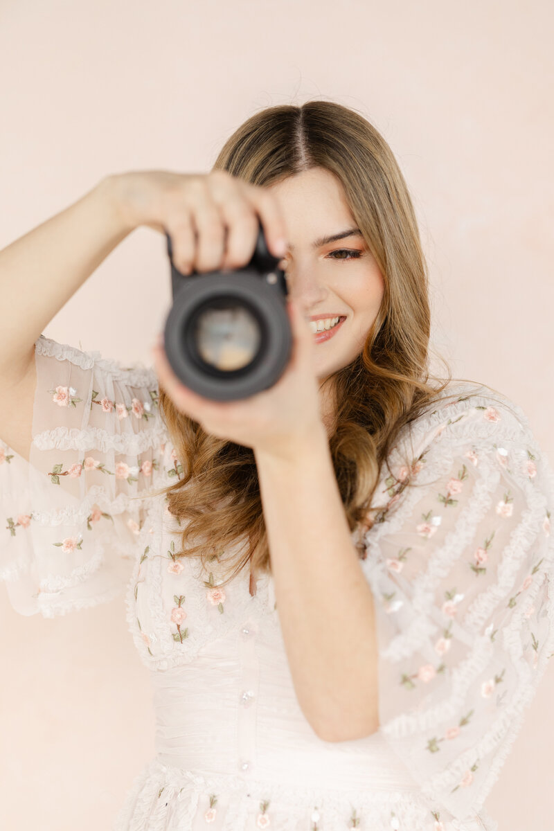 Liana Huot from Lia Rose Weddings is captured while photographing detail images of a bride and groom's wedding.