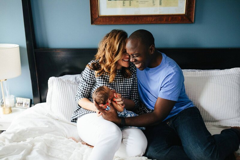 brooklyn family photo of newborn with parents laughing in bed