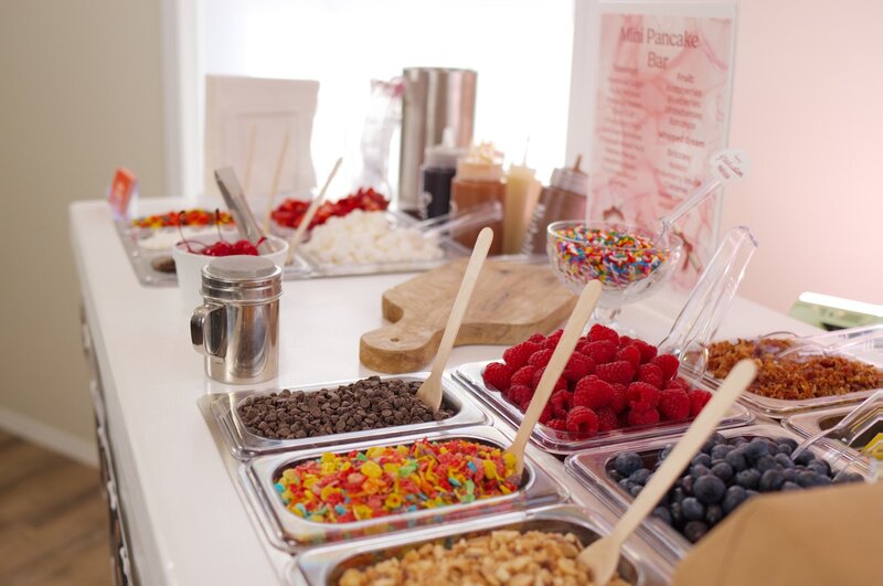 Mini pancake bar with balloon garland at party