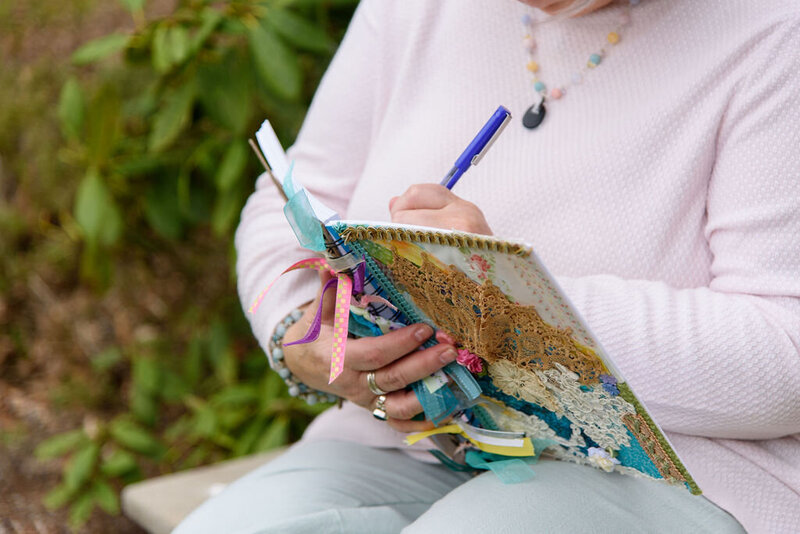 Closeup of April holding her journal while writing in it