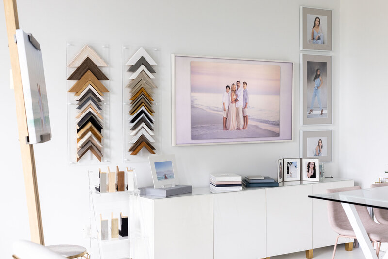 Photos hung up on a wall next to different types of frames